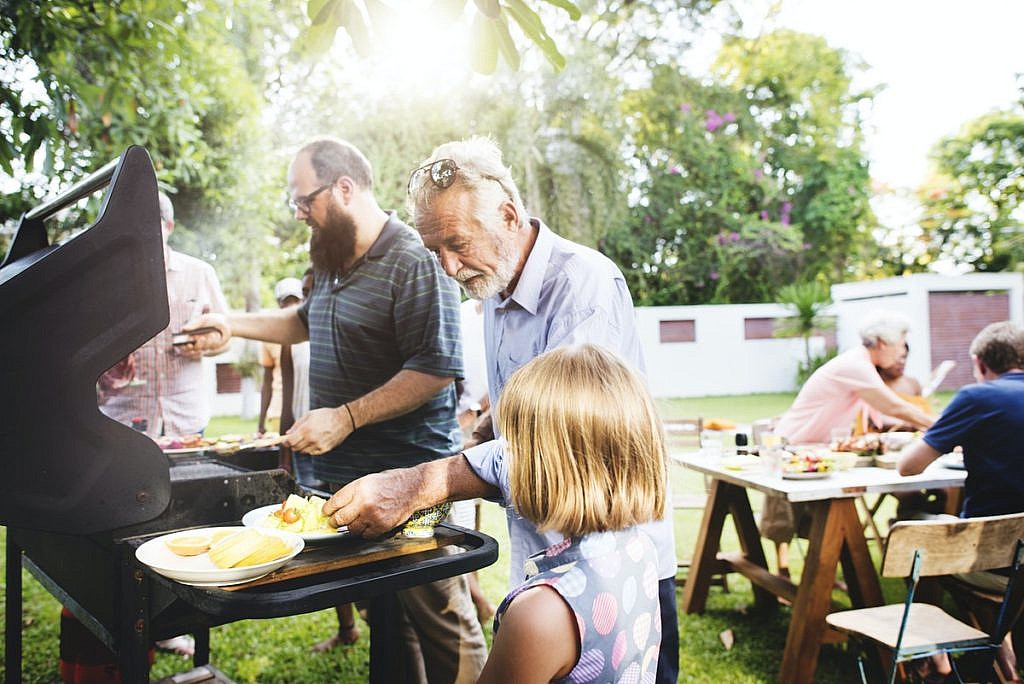 Family grilling together in a backyard