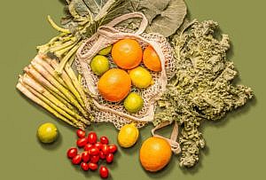 green background with fruits and vegetables spread out